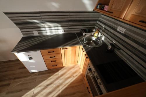 a kitchen with a sink and a counter top at Zlatar Eyes in Nova Varoš