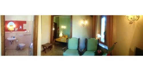 a bathroom with two blue chairs in a room at Hotel Villa Herzog in Dresden