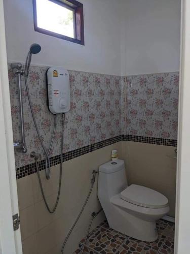 a bathroom with a shower and a toilet at Near & Far in Ko Lanta