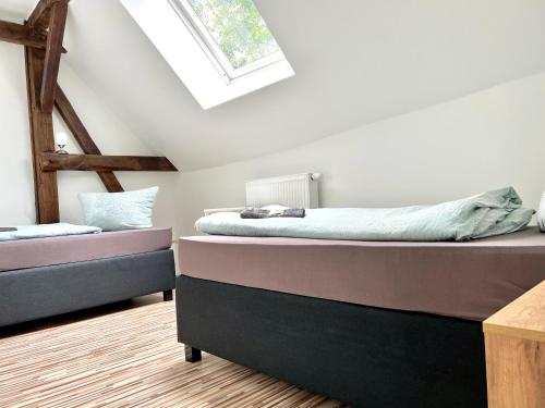 a bedroom with two beds and a skylight at Monteurwohnung am Flughafen in Schkeuditz