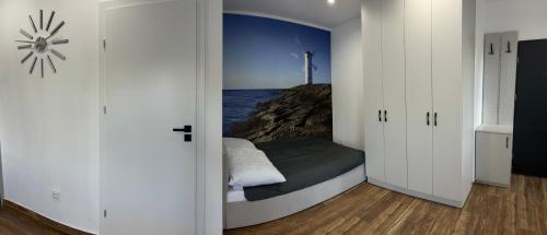 a bedroom with a bed with a view of the ocean at Apartament Magdalenka in Strzelce Opolskie