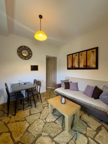 a living room with a couch and a table at Evilion Ktima Argyropoulou in Katarrákhion