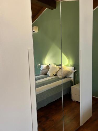 a bedroom with a bed with a glass door at Al Vicolo Uno in Montemagno