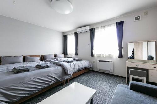 Postel nebo postele na pokoji v ubytování The North Peak Furano202