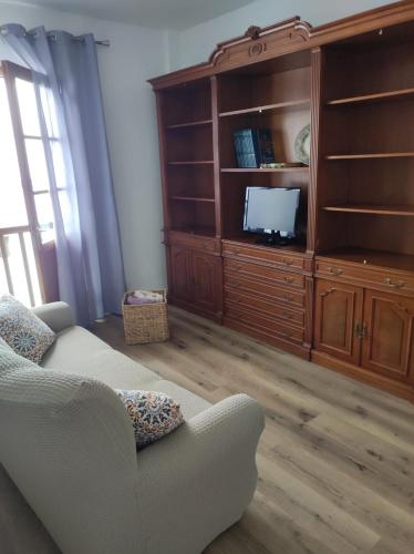 a living room with a couch and a entertainment center at Casa Rosales in La Orotava