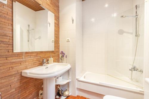 a bathroom with a sink and a shower and a tub at Cal Comorera in Masoteras