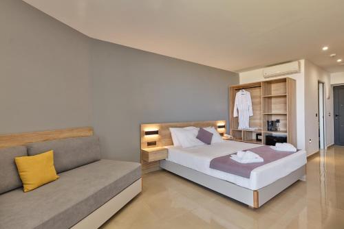 a bedroom with a bed and a couch at Galini Palace in Kolymvari
