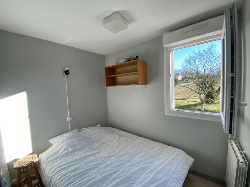 une petite chambre avec un lit et une fenêtre dans l'établissement T2 avec Terrasse à 100m des Thermes, WI-FI - FR-1-541-140, à La Roche-Posay