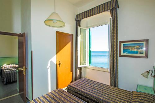 Postel nebo postele na pokoji v ubytování Hotel Baia