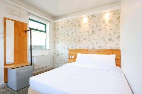 Rúm í herbergi á B & B Cheung Chau