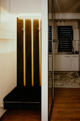 a sliding glass door with a black couch in a room at Best House in Botoşani