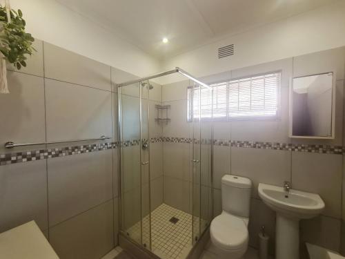 a bathroom with a shower and a toilet and a sink at Riverglades 1 in Margate