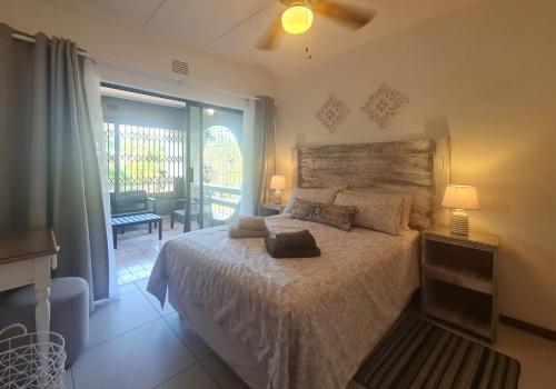 a bedroom with a bed and a large window at Riverglades 1 in Margate