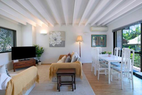 a living room with a couch and a table at Clarence Corner - Contemporary meets Cottage Style in Brisbane