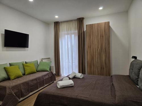 a living room with a couch and a bed at Be Your Home - La Darsena Guest House in Civitavecchia