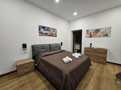 a bedroom with a bed with two towels on it at Be Your Home - La Darsena Guest House in Civitavecchia