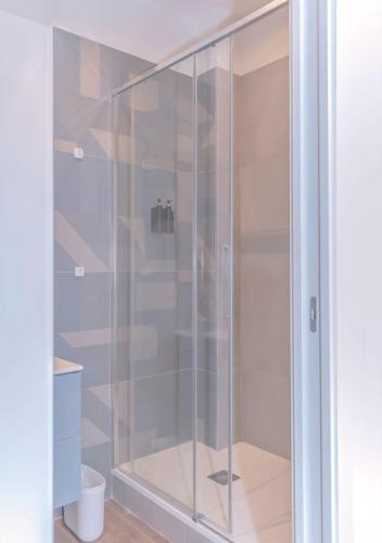 a shower with a glass door in a bathroom at Latte e Letto in Avellino