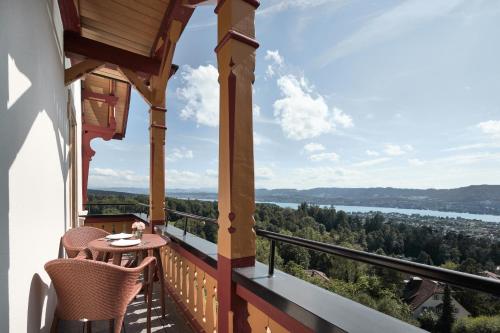 a balcony with a table and chairs and a view at The Dolder Grand - City and Spa Resort Zurich in Zürich