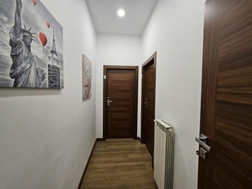a hallway with a wooden door and a hallway sidx sidx at Be Your Home - La Darsena Guest House in Civitavecchia