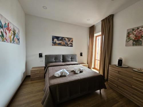 a bedroom with a bed with two towels on it at Be Your Home - La Darsena Guest House in Civitavecchia