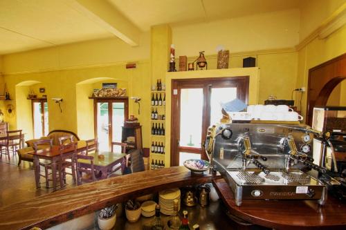 a kitchen with a stove and a dining room at Hotel Baia in Monterosso al Mare