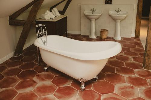 a bath tub and two sinks in a bathroom at Domaine de Bassibé in Ségos
