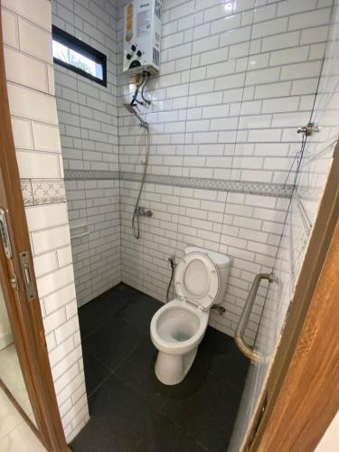 a small bathroom with a toilet in a stall at Kamar no 1 in Sampal 2