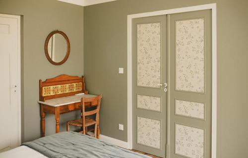 a bedroom with a bed and a desk and a door at Domaine de Bassibé in Ségos