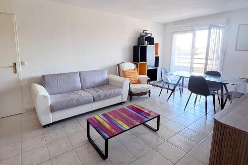 a living room with a couch and a table at Les boucaniers in Berck-sur-Mer