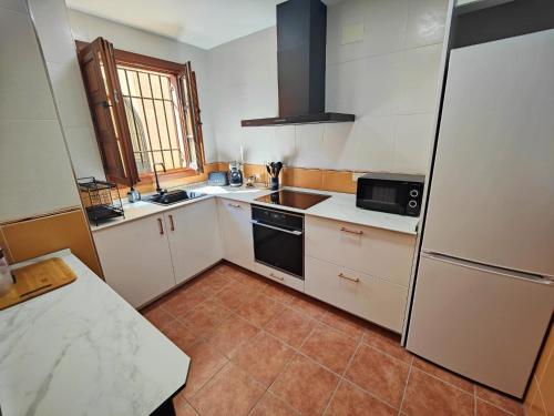 a kitchen with a sink and a refrigerator at Casa Cincilia in Chinchilla de Monte Aragón