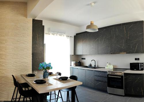 a kitchen with a wooden table and a dining room at Margarita in Chania