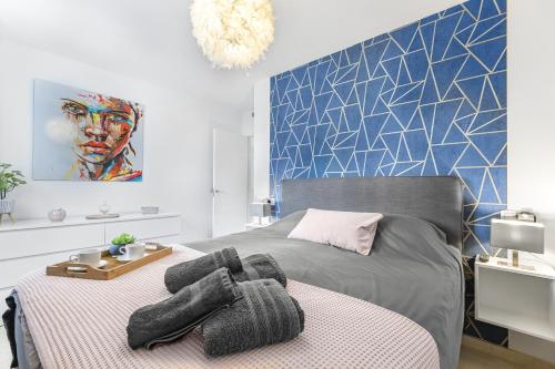 a bedroom with a bed with two gloves on it at Sungolfbeach El Girasol in Orihuela