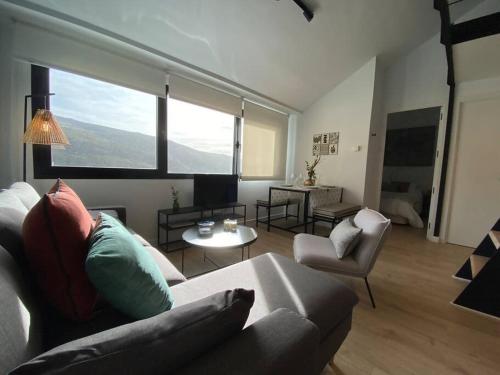 a living room with a couch and a table at Skade Sierra Nevada Zona Baja in Sierra Nevada