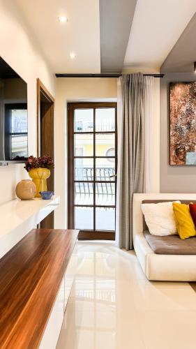 a living room with a white couch and a window at Stella Di Mare in Zakopane