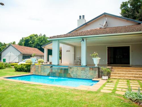 a swimming pool in the backyard of a house at Hudson Haven Bed & Breakfast in Pietermaritzburg