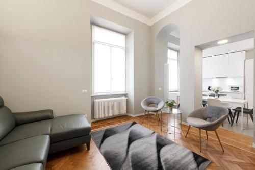 a living room with a couch and chairs and a table at Milan Royal Suites - Centro in Milan