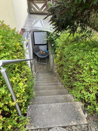 a stairway with a table and a chair on it at Nettes Apartment mit schönem Bad in Bergneustadt