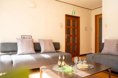 a living room with a couch and a table at Extreme in Sapporo