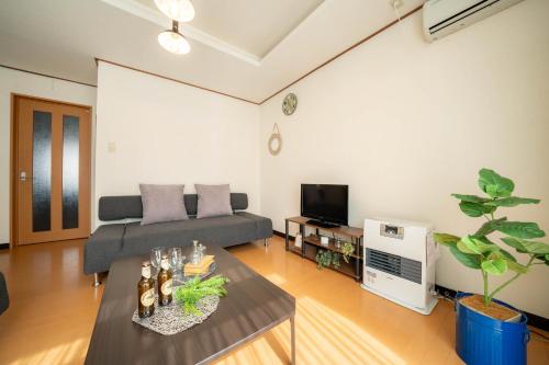 a living room with a couch and a table at Extreme in Sapporo