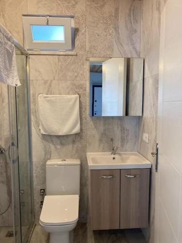 a bathroom with a toilet and a sink and a mirror at Magnificent sunset view in Fethiye