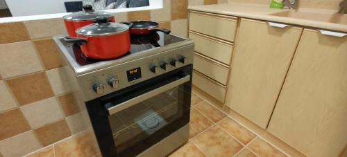 a kitchen with a stove with two pots on it at Ban Luxury Apartments in Al Khobar