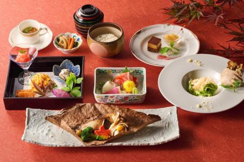 a table with plates of food and bowls of food at Hotel Laforet Nasu in Nasu