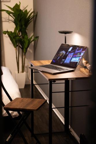 a laptop computer sitting on top of a desk at Nagomi Gokoro Village Shin-Osaka in Osaka