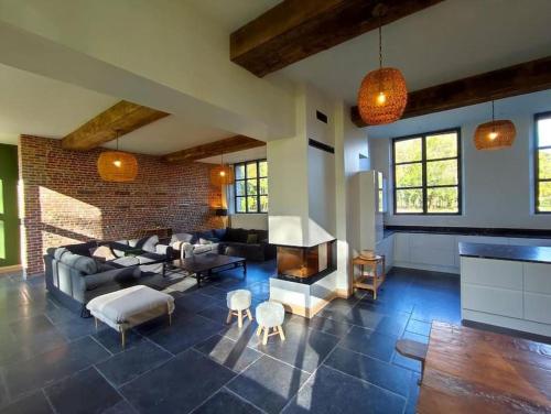 un salon avec un canapé et une cheminée dans l'établissement grande maison de campagne, à Saint-Jean-du-Cardonnay