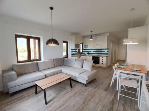 a living room with a couch and a table at Anamesa Apartment 1 in Poúlithra