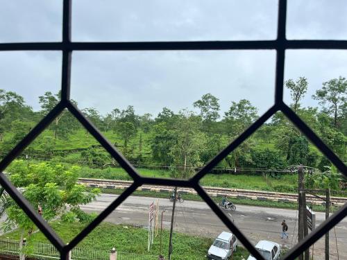 a view of a road from a window at KG Complex Dhuwa Chang Stay in Mohanbāri