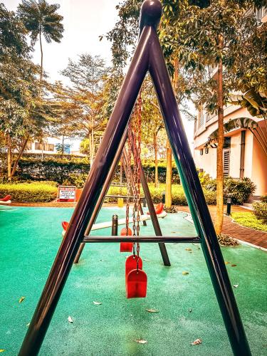 a swing set in a park with a playground at Natural Haven at South in Manila
