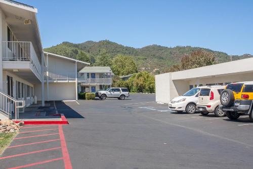 a parking lot with cars parked in front of a building at Motel 6-Ukiah, CA in Ukiah