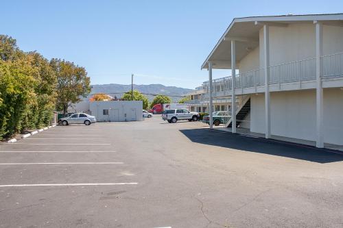 a parking lot next to a building with cars parked at Motel 6-Ukiah, CA in Ukiah