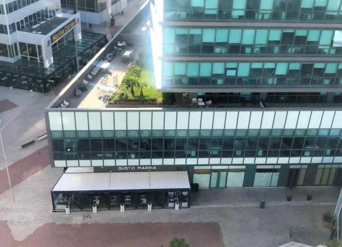 an overhead view of a tall building with a parking lot at Marina casablanca in Casablanca
